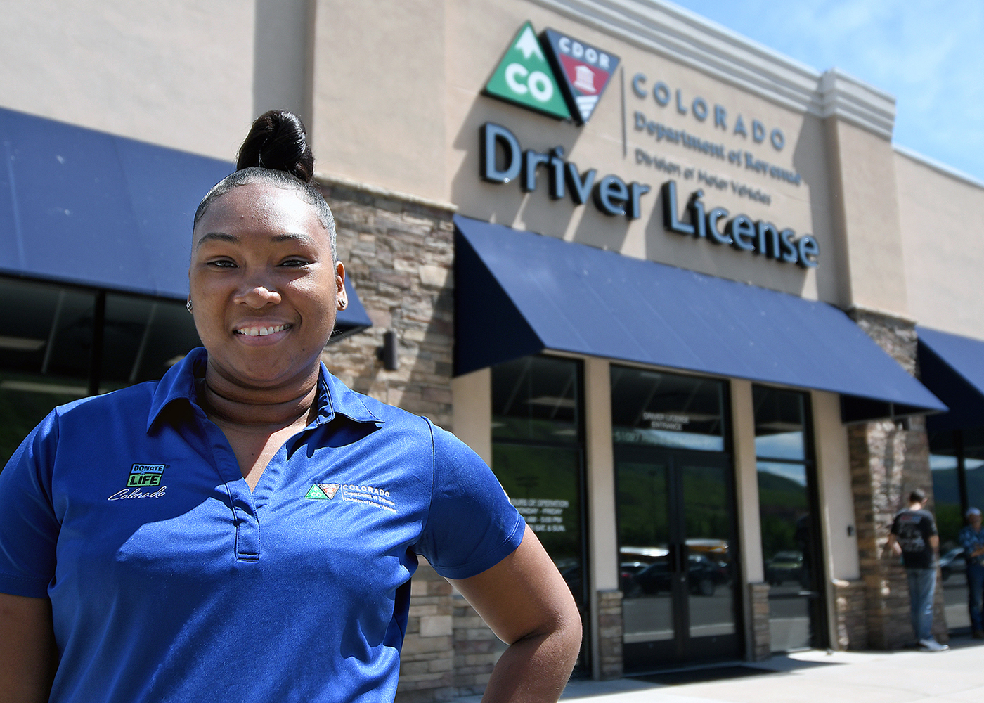 DMV Team Member stands in front of a driver license office
