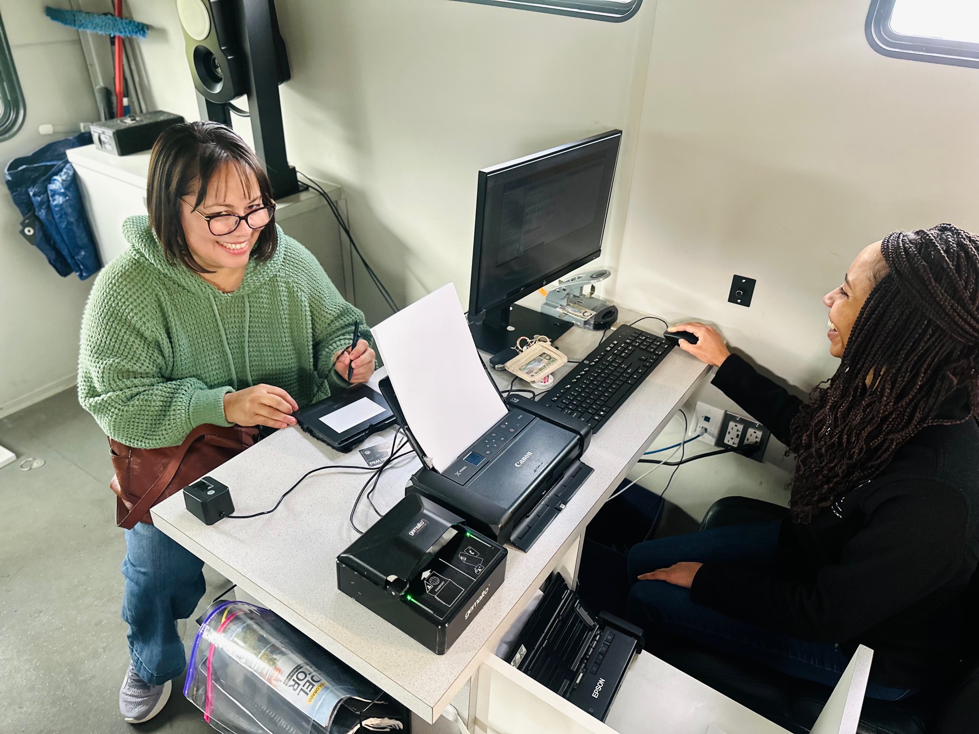 DMV2GO Team Members serve Coloradans inside the DMV2GO RV in Denver